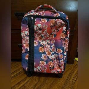 LeSportsac rolling duffel bag featuring a vibrant floral pattern